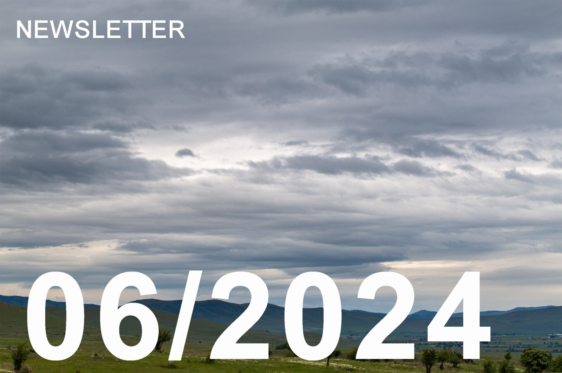 photo of grey skies on the horizon over a green landscape.